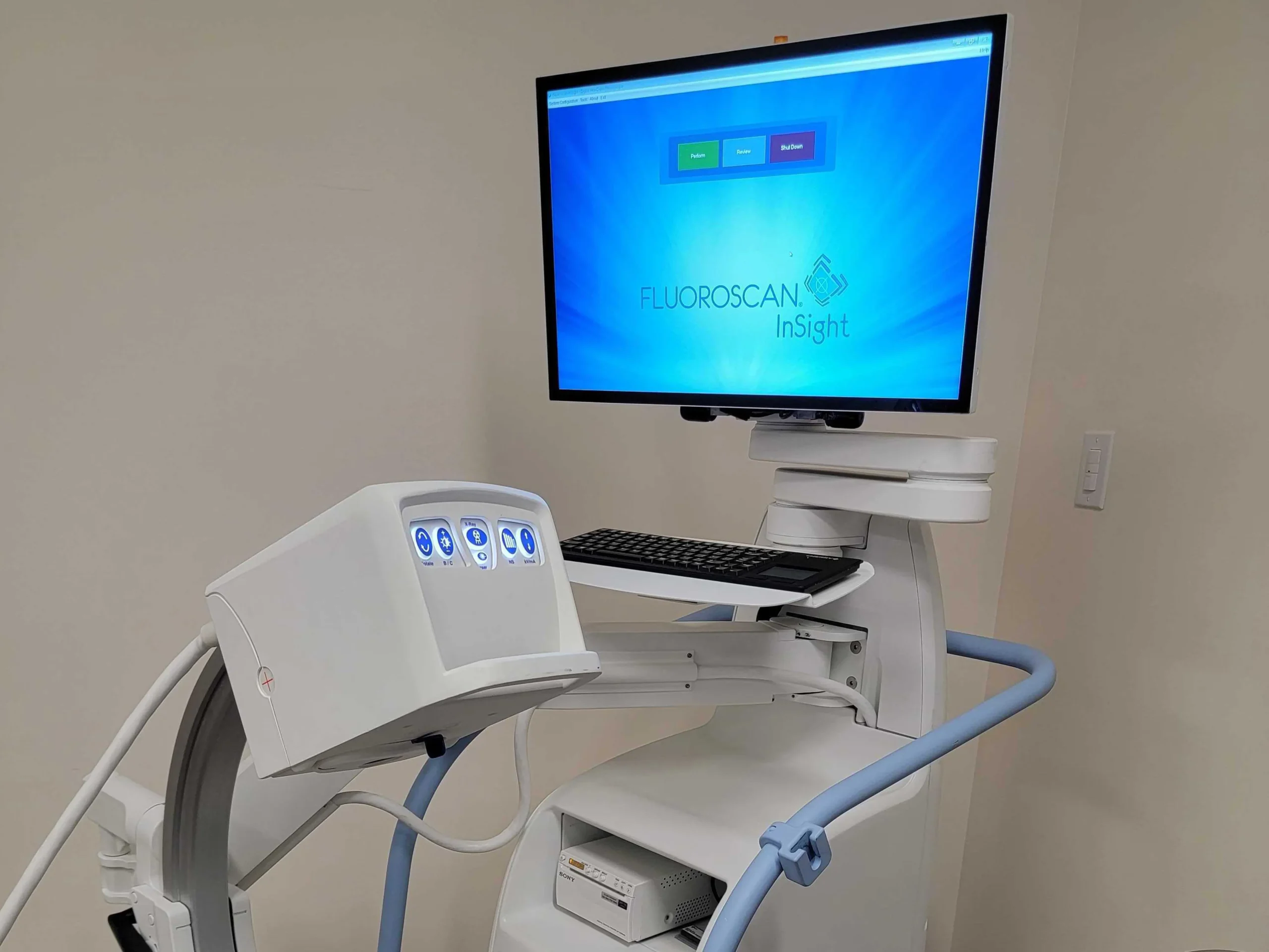 computer monitor sitting on top of a white cart