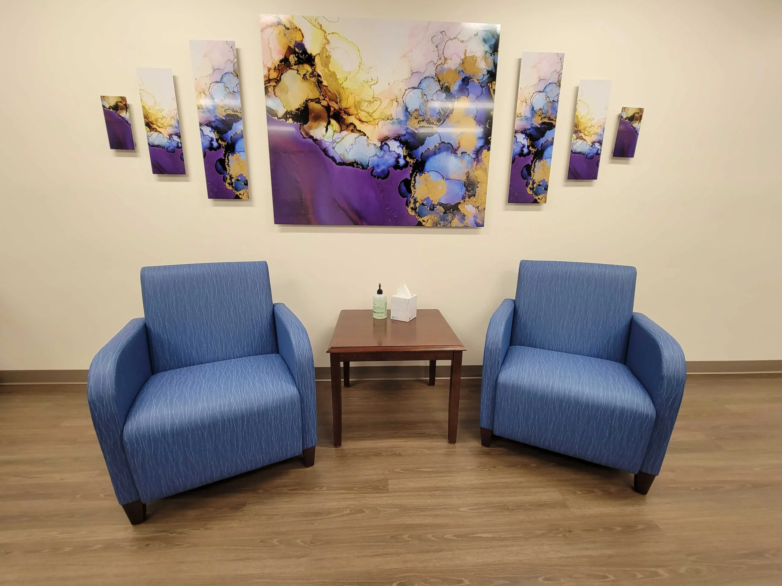 couple of blue chairs sitting next to a table