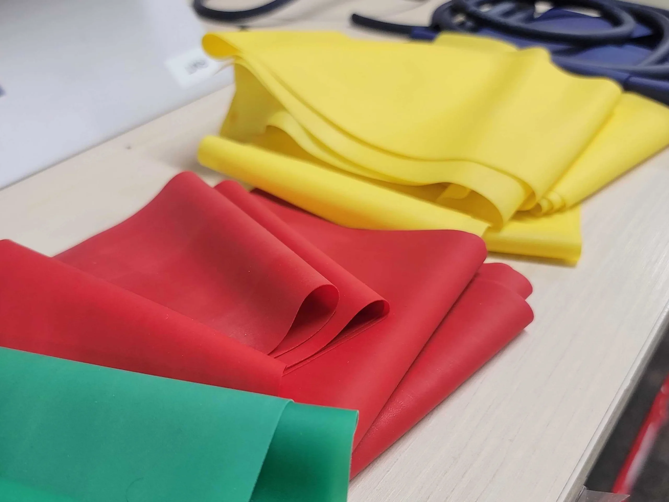 table topped with lots of different colored sheets of paper