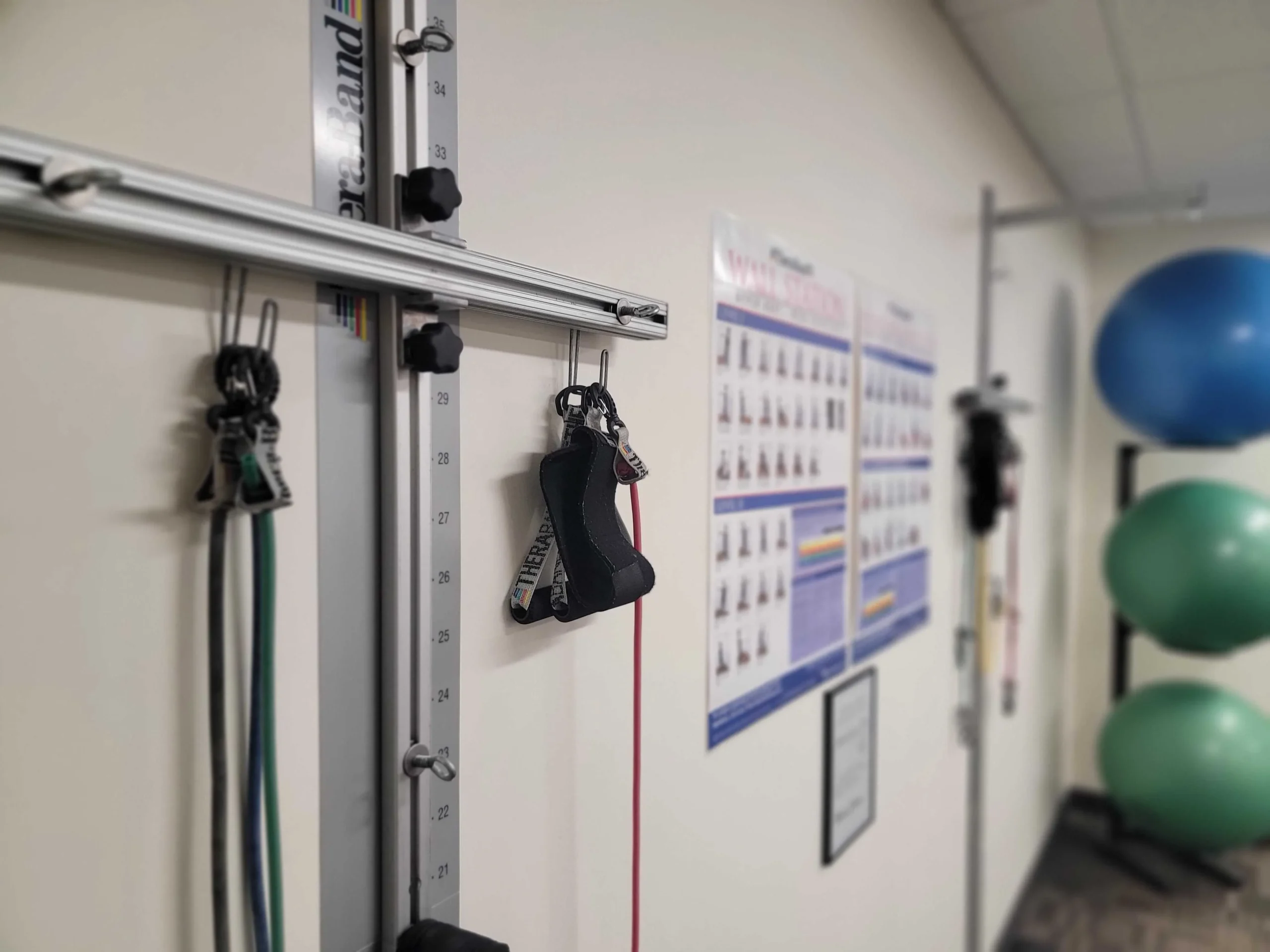 wall with a bunch of exercise equipment hanging on it